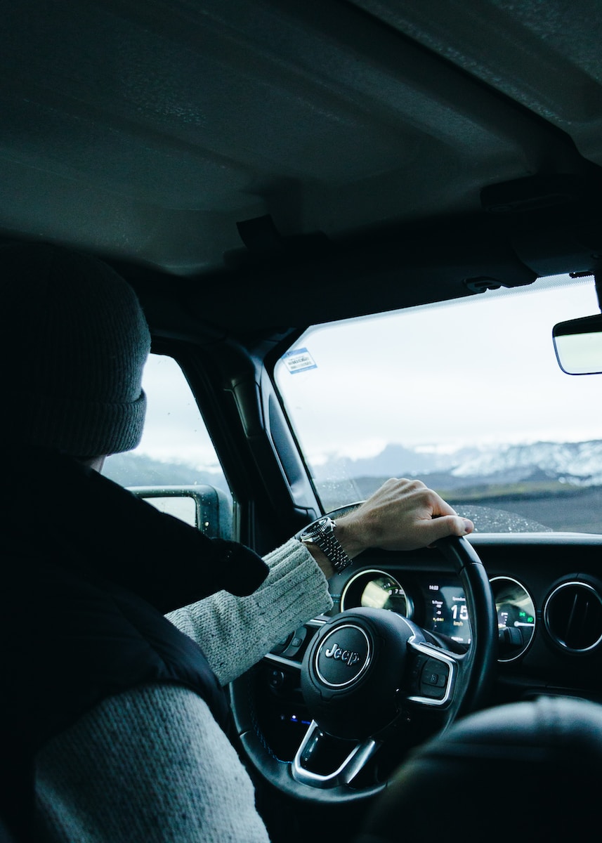 a person driving a car on a road