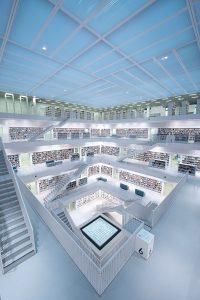 a room filled with lots of books and stairs