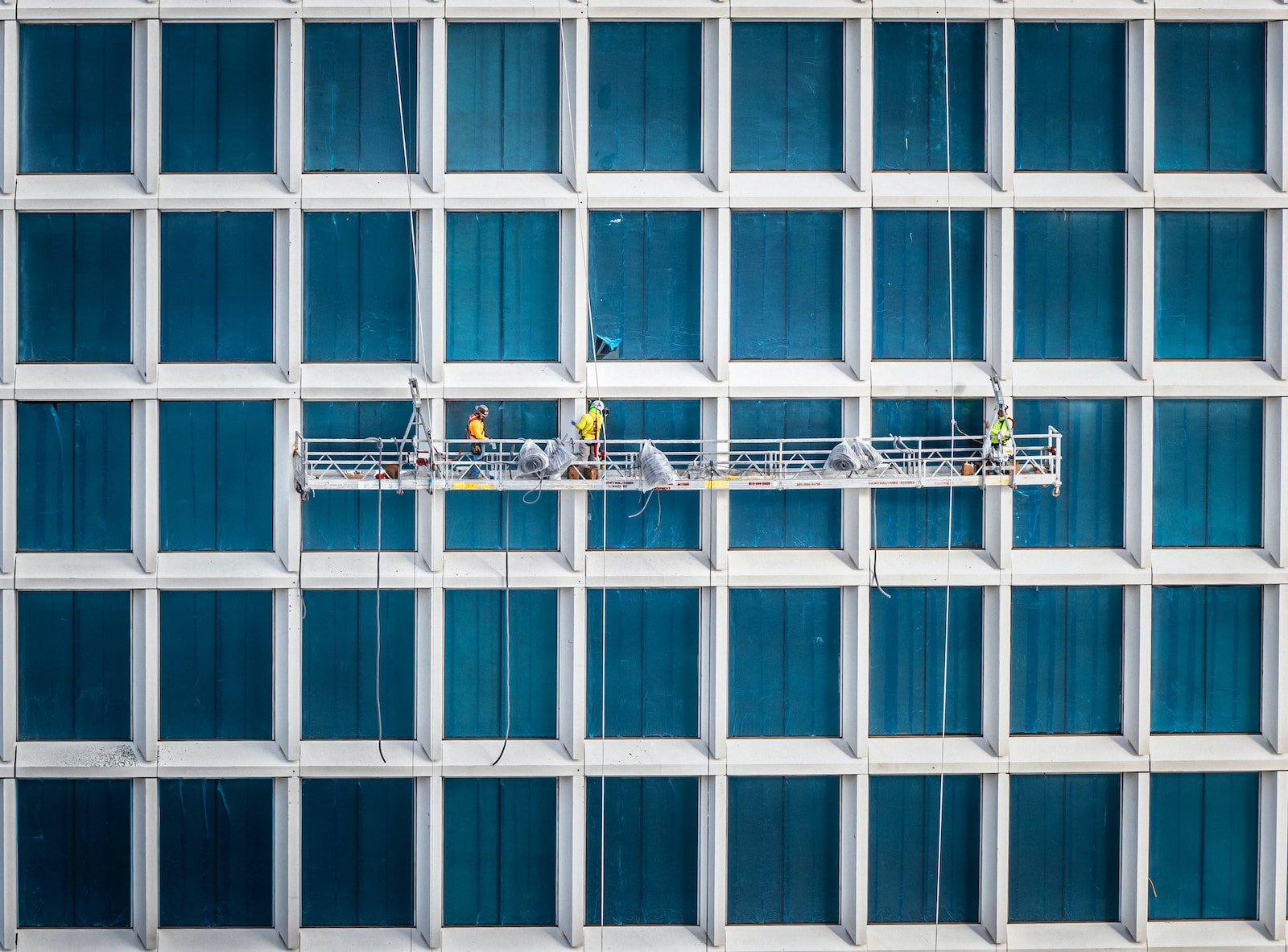 a group of people standing on a scaffold in front of a building